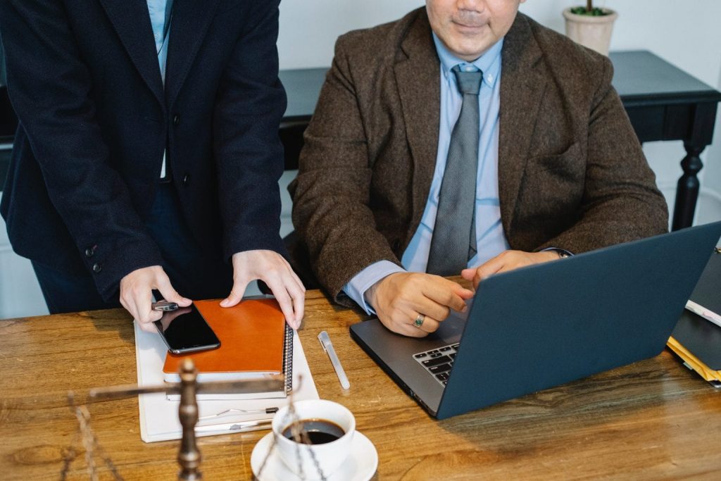 A legal professional and his colleague sitting at a table