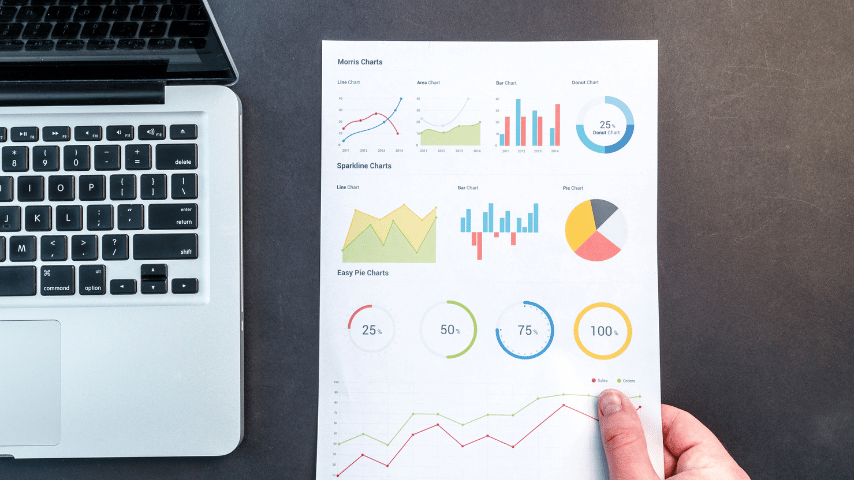 Person holding chart and bar graph