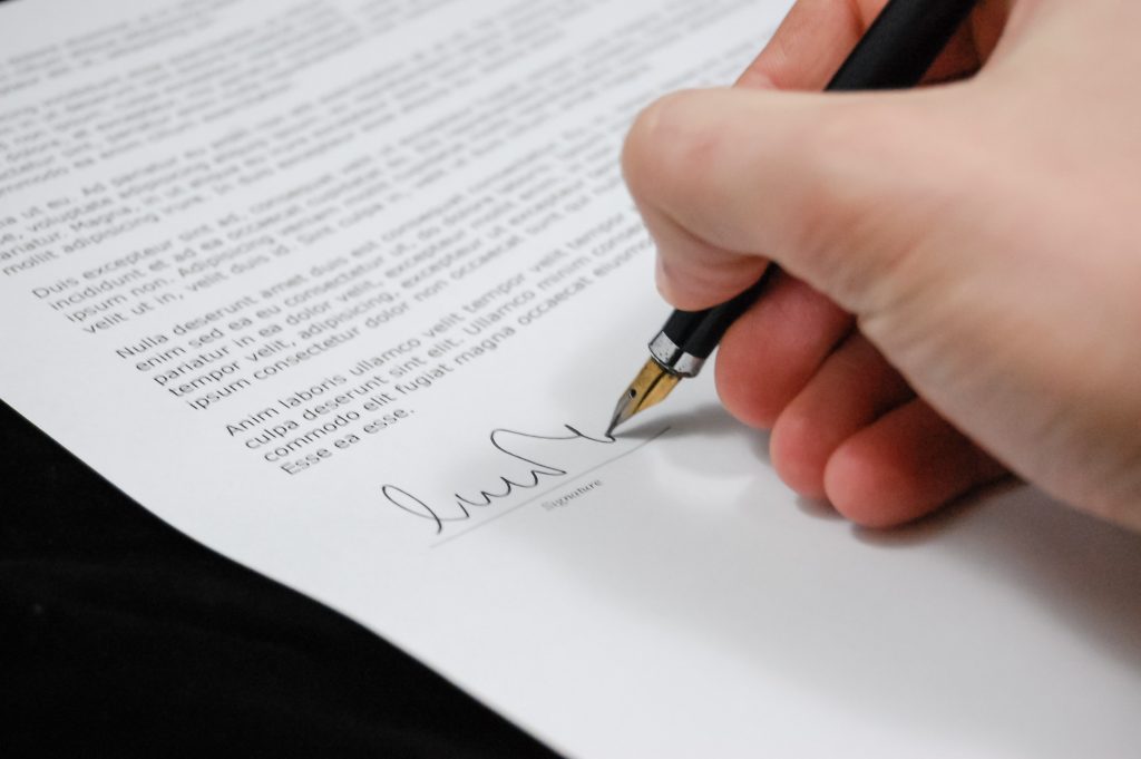 A legal person signing off a document